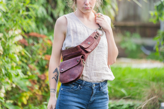 Leather hip bag worn while walking outdoors